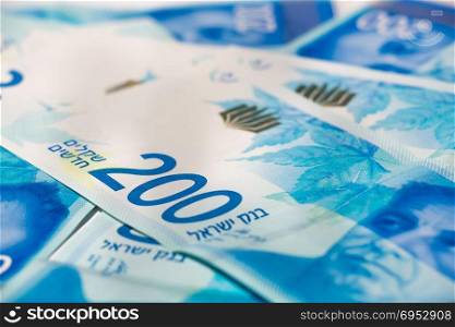 Stack of Israeli money bills of 200 shekel.
