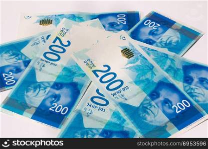Stack of Israeli money bills of 200 shekel.