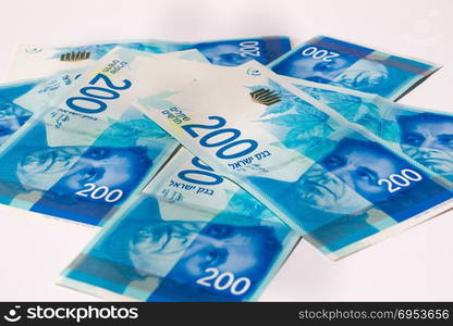 Stack of Israeli money bills of 200 shekel.