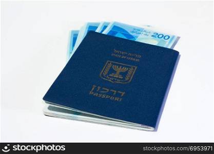 Stack of israeli money bills of 200 shekel and israeli passport.