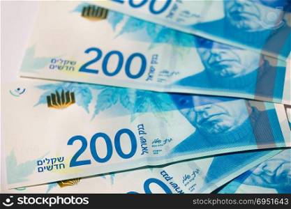Stack of Israeli money bills of 200 shekel - top view.