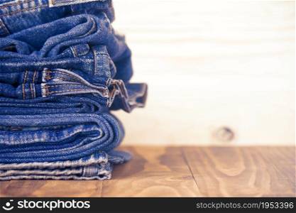 Stack Of Jeans On Old Wood Flooring, Fashion Concept