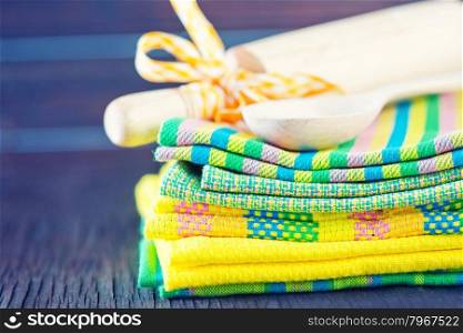 stack of kitchen towels on the wooden table