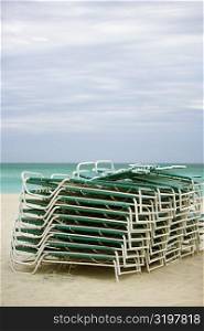 Stack of lounge chairs on the beach