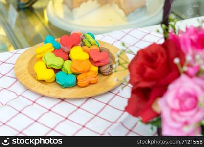 stack of macaron heart shape dessert on woodent plate