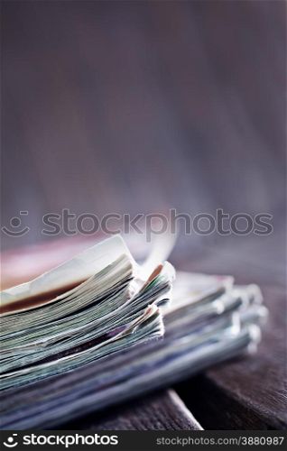 stack of magazines on the wooden table