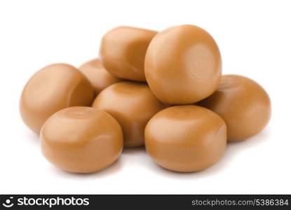 Stack of milk caramel candies isolated on white