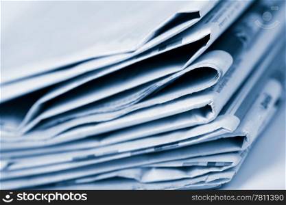 stack of newspapers toned blue
