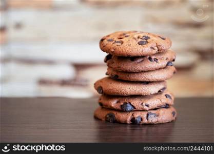 Stack of oatmeal cookies with chocolate on a wooden table. Stack of oatmeal cookies with chocolate on wooden table