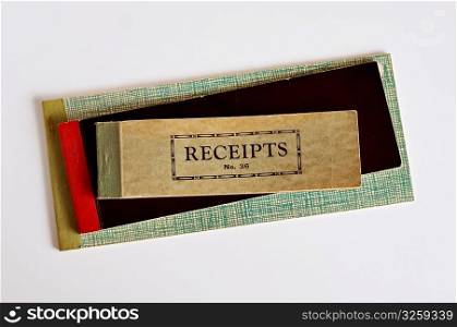 Stack of old vintage receipt books on white background.