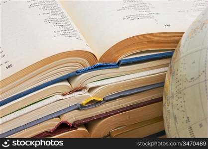 stack of open books and Globe