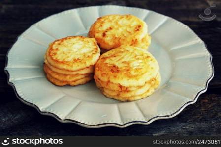 Stack of pancakes on wooden dark background.
