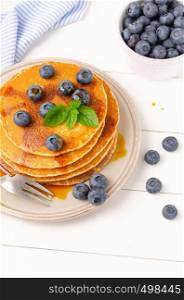Stack of pancakes with fresh blueberry and caramel syrup.