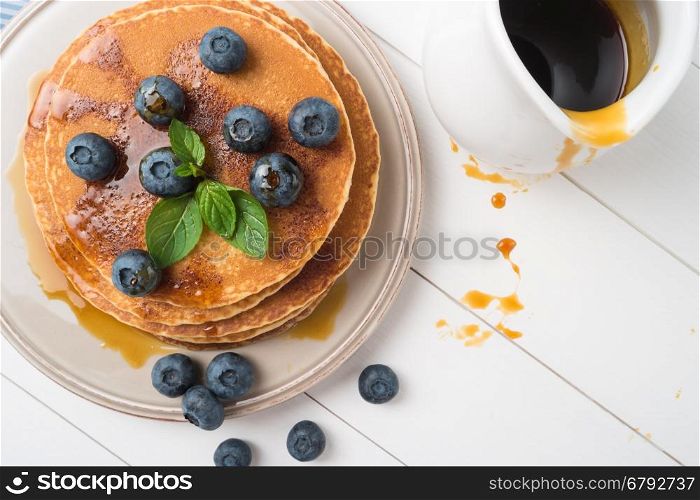Stack of pancakes with fresh blueberry and caramel syrup. Top view