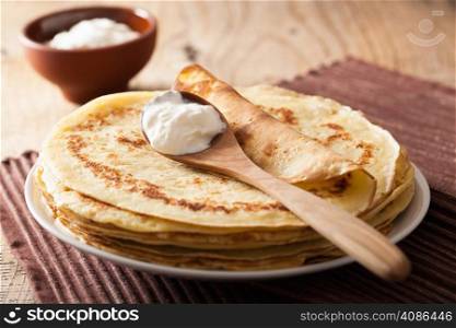 stack of pancakes with sour cream