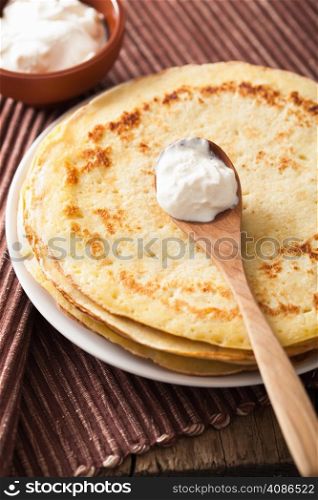 stack of pancakes with sour cream