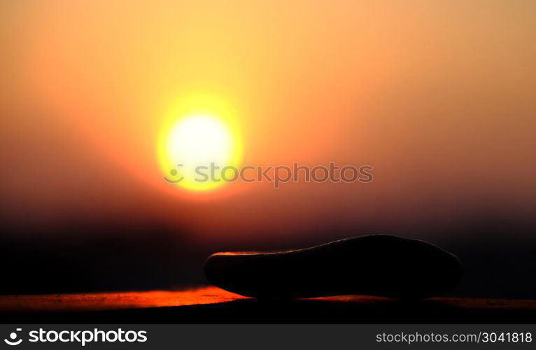 stack of pebble on yellow sun background. Amazing shape of stack of pebble on yellow sun background at sunrise, three stones balance make abstract art