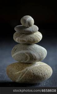 stack of pebble stones on black background