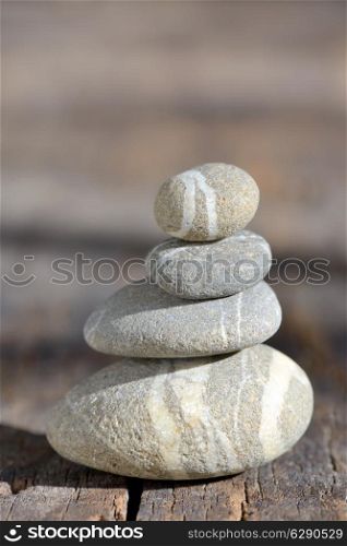 Stack of pebble stones on wood