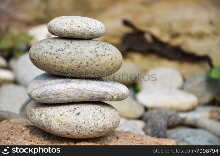 Stack of pebbles with rocky background. Concept of balance.. Pyramid of pebbles