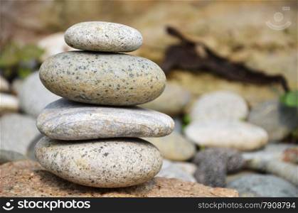 Stack of pebbles with rocky background. Concept of balance.. Pyramid of pebbles