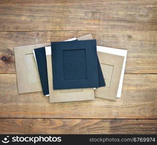 stack of photo frames on wooden background