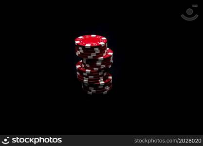 Stack of poker chips on black background