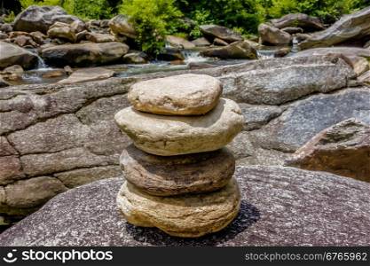 Stack of round smooth stones near mountain river