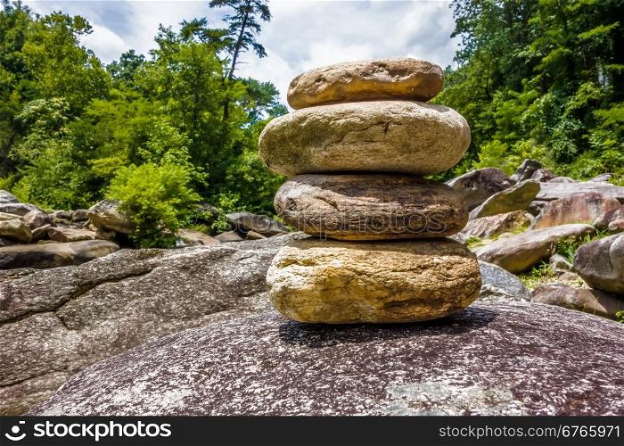 Stack of round smooth stones near mountain river
