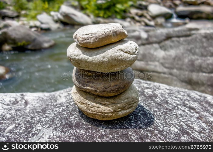 Stack of round smooth stones near mountain river