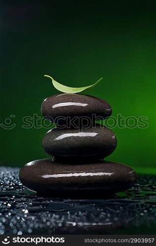Stack of spa stones over color background
