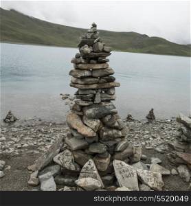 Stack of stones at the lakeside, Yamdrok Lake, Nagarze, Shannan, Tibet, China