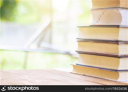 Stack Of Thick Books With Beautiful Light And Bokeh Background.