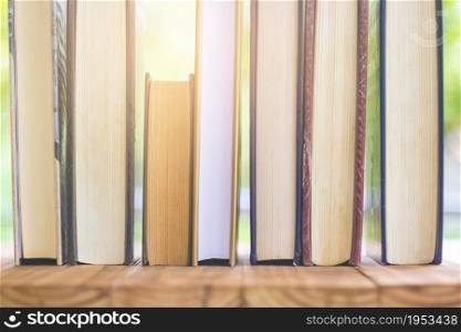 Stack Of Thick Books With Beautiful Light And Bokeh Background.