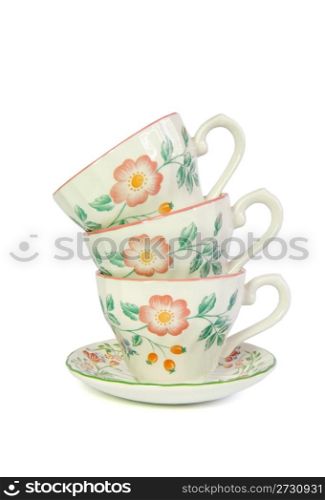 Stack of three porcelain tea cups isolated