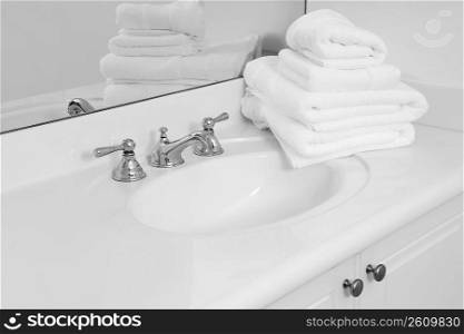 Stack of towels on a bathroom sink