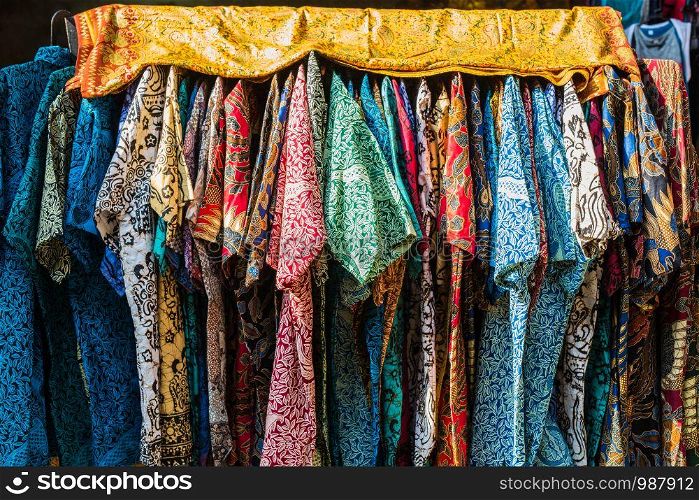 stack of traditional colourful sarong in a row on the market in Indonesia colorful. stack of traditional colourful sarong in a row on the market in Indonesia