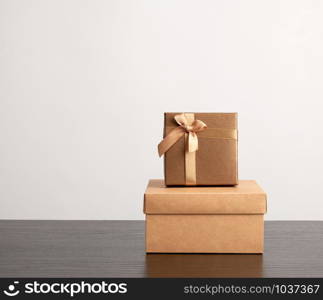 stack of various cardboard boxes for gifts on a black table, white background