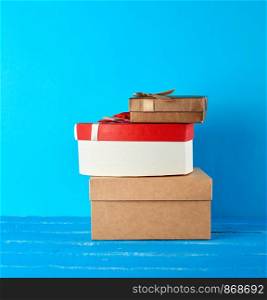 stack of various cardboard boxes on a blue background, festive backdrop