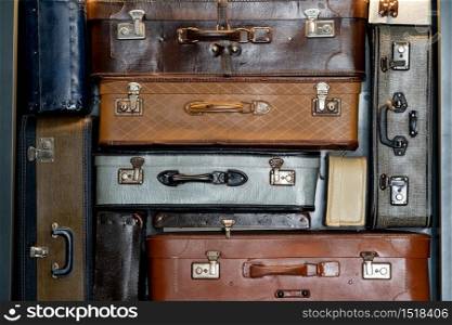 Stack of vintage leather suitcases background
