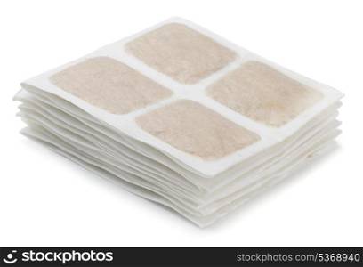 Stack of warm mustard plasters isolated on white