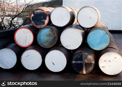 Stack of whisky barrels outside of distillery