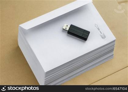 Stack of white envelopes and USB flash memory drive as concept