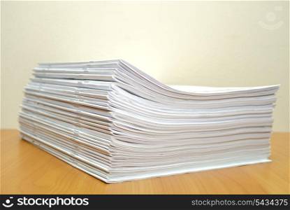 Stack of white journals in office desktop. Shallow deep of field