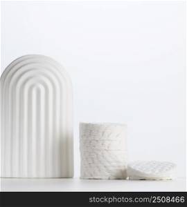 Stack of white round cotton cosmetic pads on the table