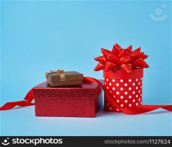 stack of wrapped gifts with knotted bows on a blue background, festive backdrop