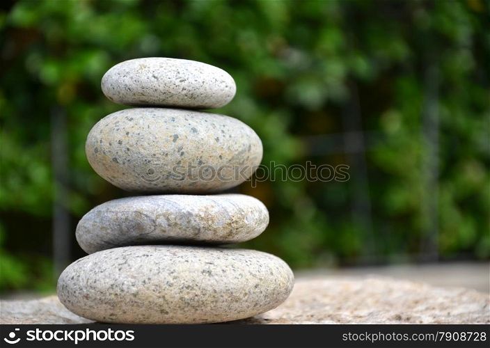 Stack of zen rocks in garden on green background. Stack of zen rocks in garden