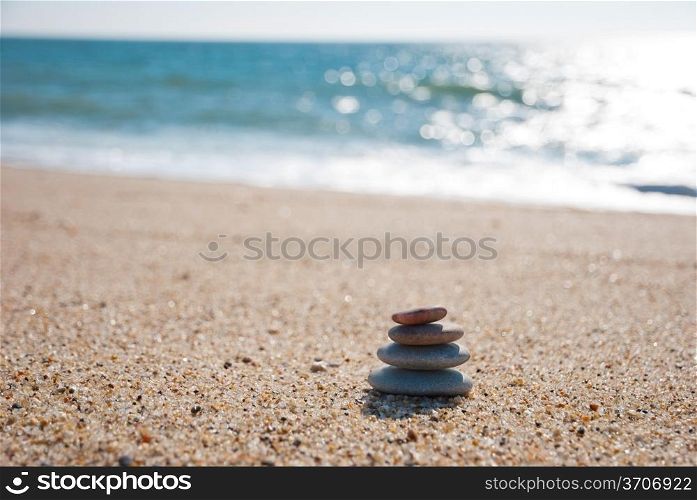 Stack on pebble stones on the beach in the back