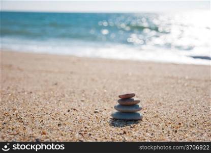 Stack on pebble stones on the beach in the back