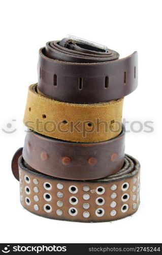 stack pile of leather belts isolated on white background